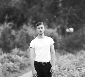 Portrait of young man standing on field