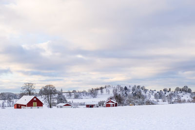 Snow covered field against sky