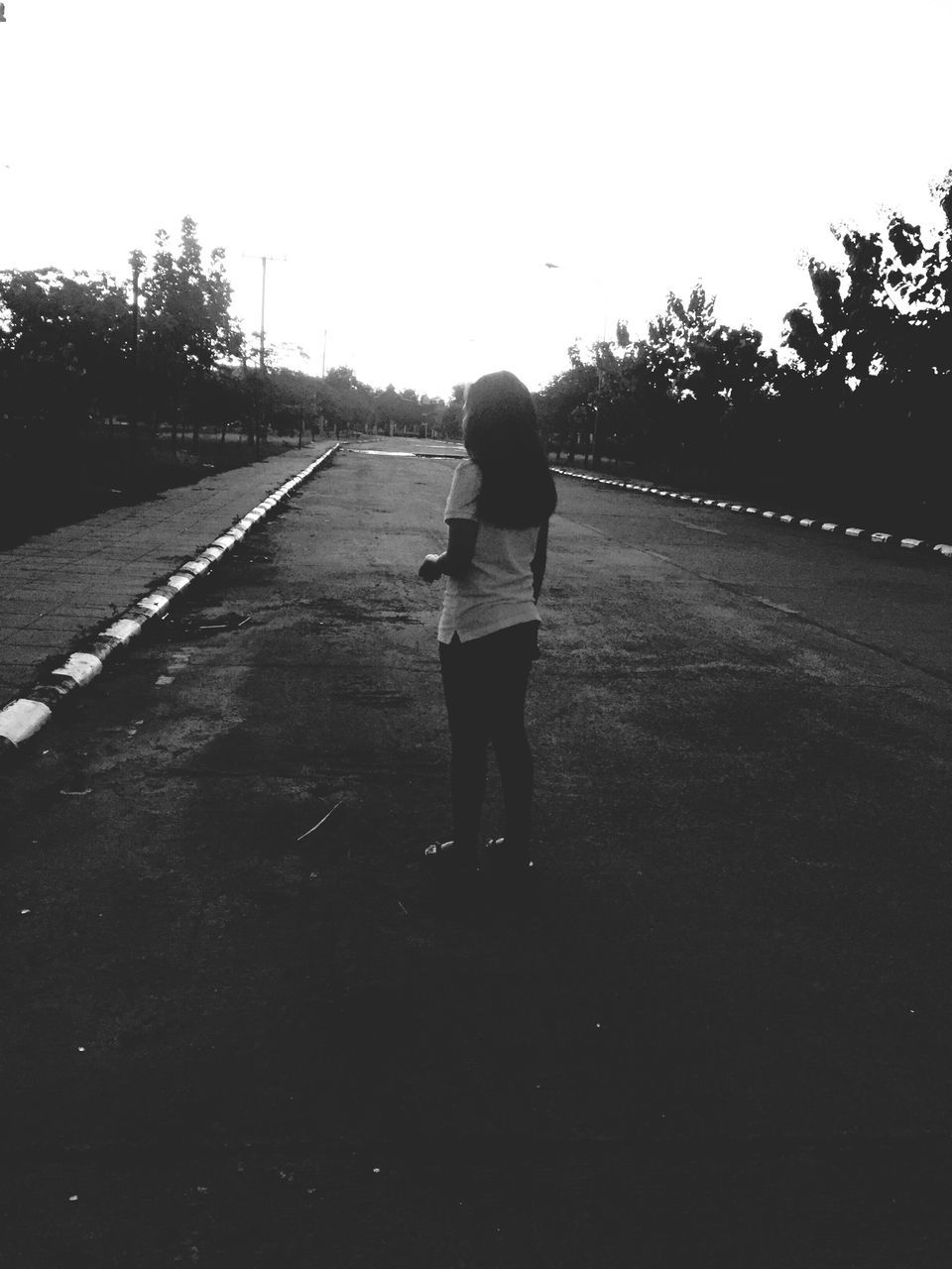 full length, rear view, the way forward, walking, lifestyles, clear sky, childhood, leisure activity, casual clothing, diminishing perspective, boys, tree, road, vanishing point, standing, street, elementary age, girls