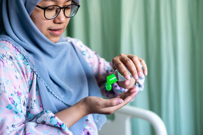 Midsection of woman using mobile phone