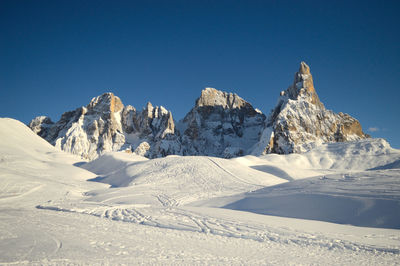 Scenic view of snowcapped mountains against clear blue sky