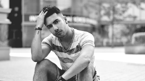 Portrait of young man sitting outdoors