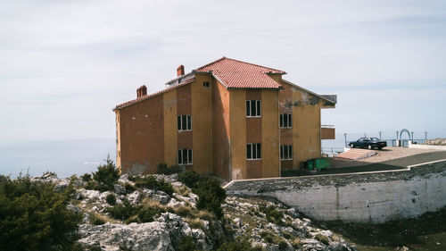 House by building against sky