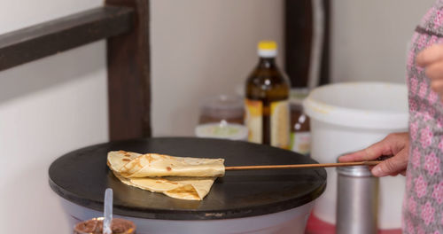 Prepare crepes on a hot plate and fold with a long wooden spoon
