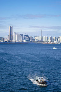 Scenic view of sea and buildings against sky