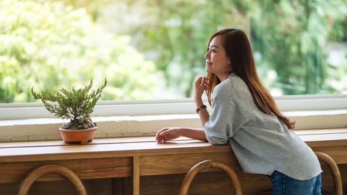 Young woman sitting on chair at park