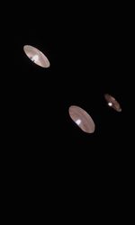 Low angle view of half moon against black sky