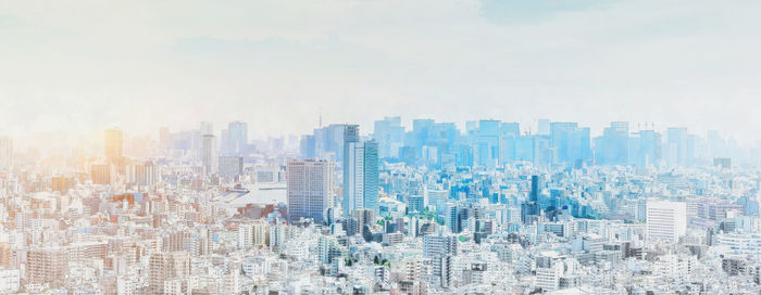 Aerial view of modern buildings in city against sky