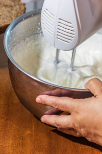 Midsection of person preparing pouring coffee in cup