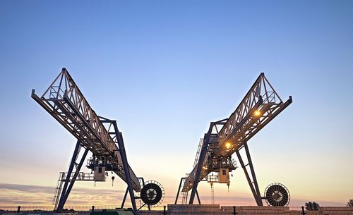 Low angle view of crane against sky