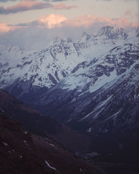 Scenic view of snowcapped mountains against sky during sunset