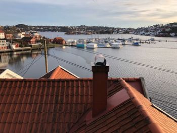 High angle view of houses by town against sky