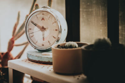 Close-up of clock on table