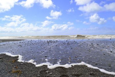 Scenic view of sea against cloudy sky