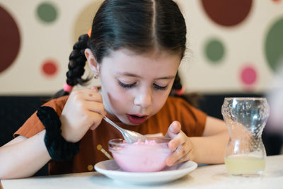 Close-up of boy eating food at home