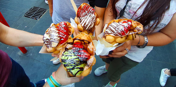 High angle view of people holding food