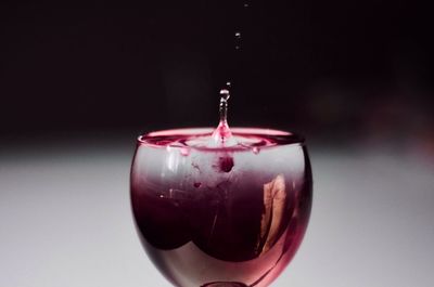 Close-up of red wine over gray background