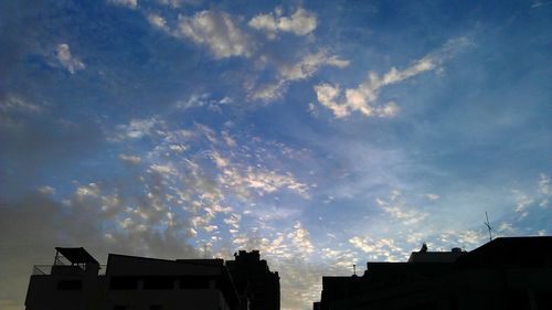 Low angle view of building against cloudy sky