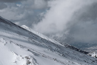 Scenic view of snow covered mountains against sky