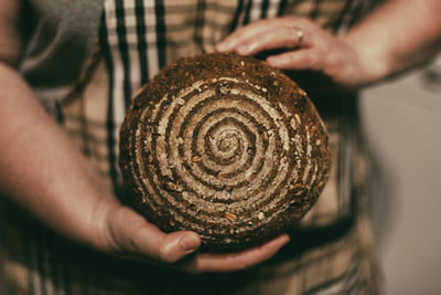 Midsection of woman holding cake roll