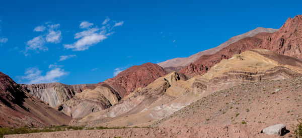 Scenic view of mountains against blue sky