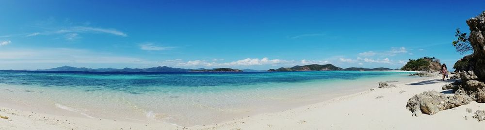 Panoramic view of beach against blue sky
