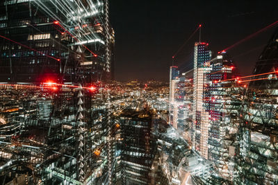 Aerial view of illuminated buildings in city at night