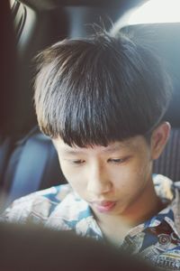 Close-up of boy sitting