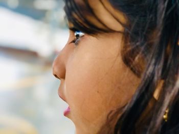 Close-up portrait of young woman looking away