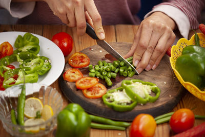 Midsection of man preparing food on cutting board