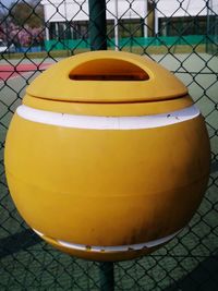 High angle view of yellow container on footpath