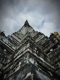 Low angle view of historic building against cloudy sky