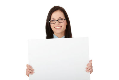 Portrait of a smiling young woman against white background