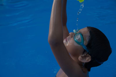 Boy swimming in pool