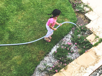 High angle view of girl playing in yard