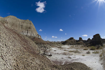 Scenic view of desert against blue sky