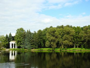 Scenic view of lake by trees against sky