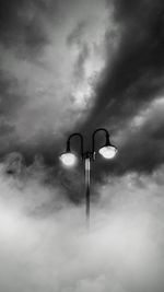 Low angle view of street light against cloudy sky