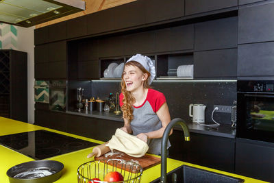 Portrait of smiling young woman working at home
