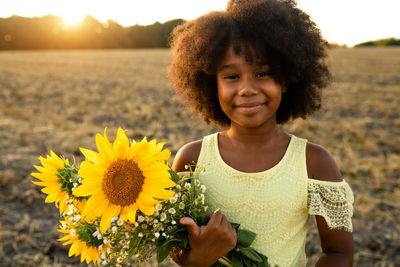 Portrait of smiling girl on sunflower field