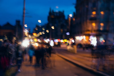 Defocused image of illuminated city street and buildings at night