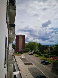 Cars on road in city against sky