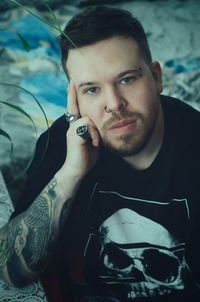 Portrait of young man sitting on field