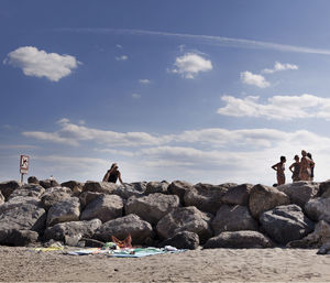 Tourists on rocks at seaside