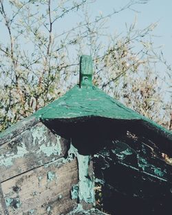 Low angle view of birdhouse on tree against sky