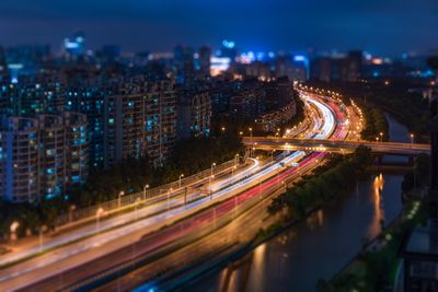 High angle view of light trails on highway in city at night