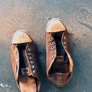 Close-up of shoes on tiled floor