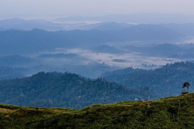 Scenic view of landscape and mountains against sky