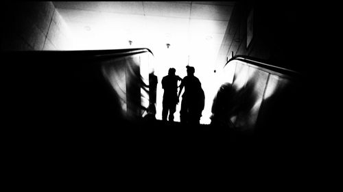 Silhouette people standing in subway