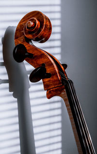 Close-up of violin against wall